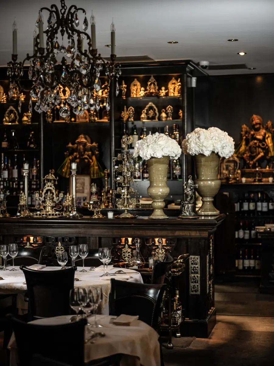 RATN dining room, gilded display cabinets, crystal chandelier and white hydrangeas