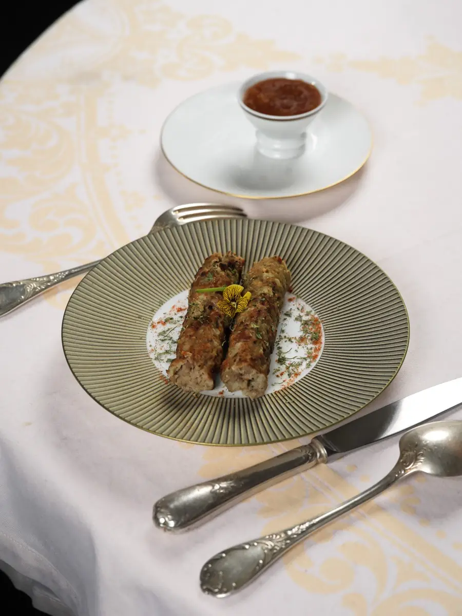Kebab and chutney on a gilded plate