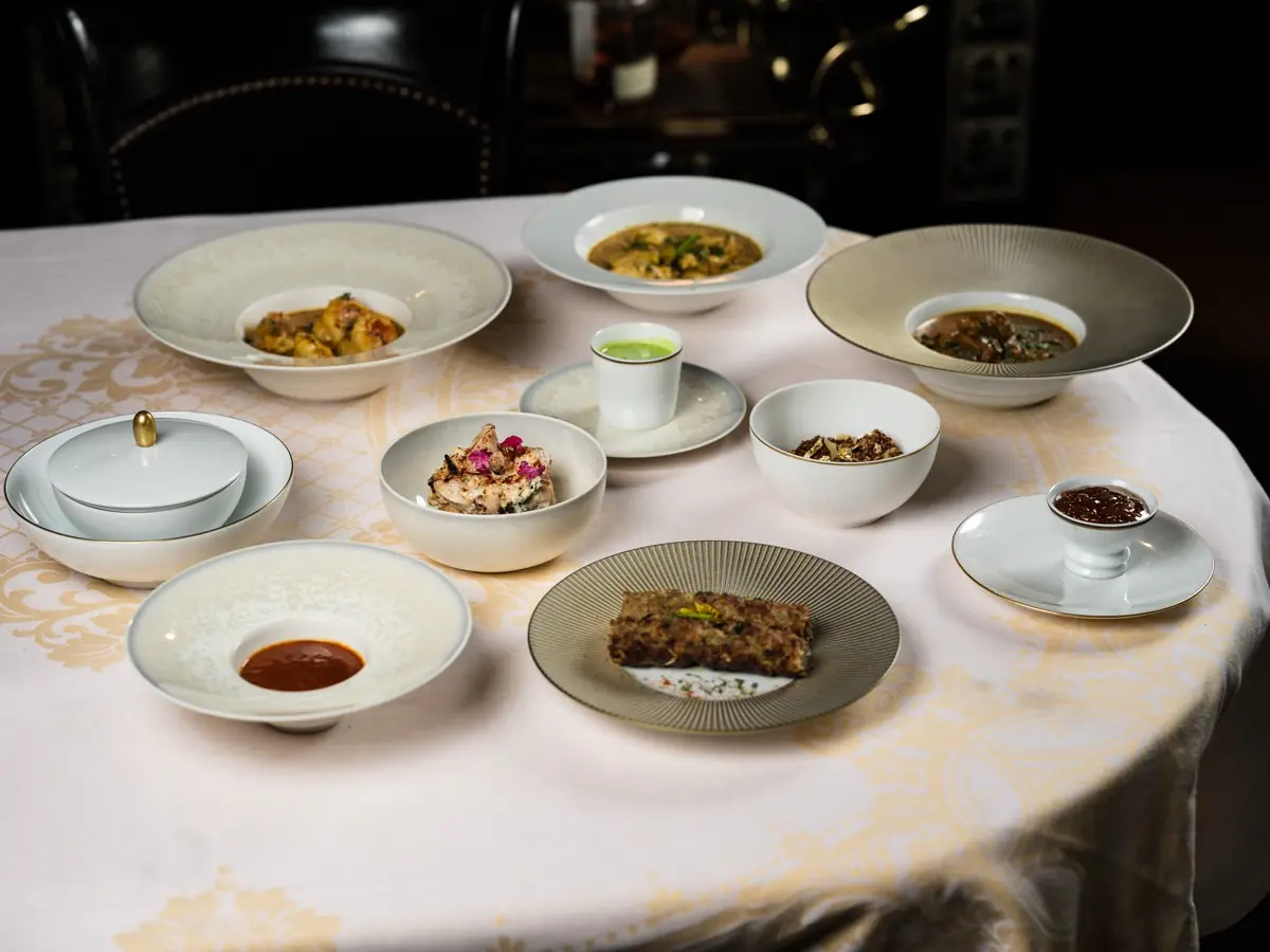 A sharing table: curry, grills, rice, dal and chutneys