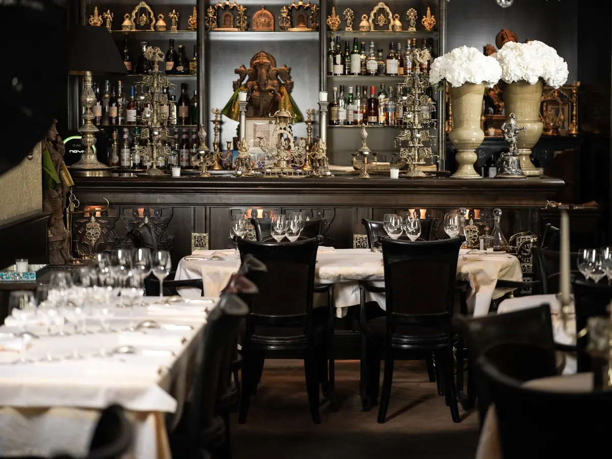 Laid tables in the dining room, black armchairs and silverware