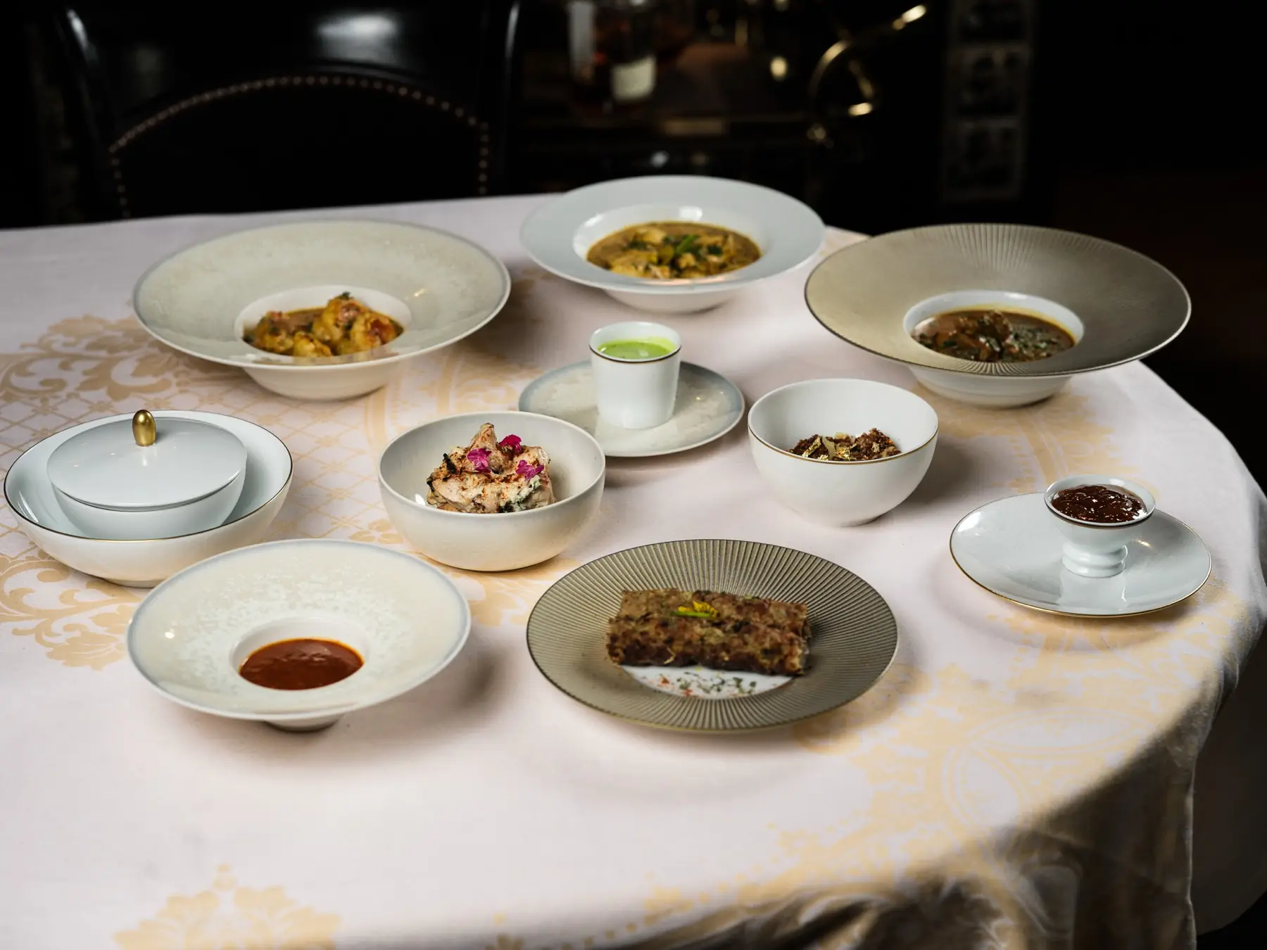 A table set with Mughlai dishes: curry, grills, rice and chutneys