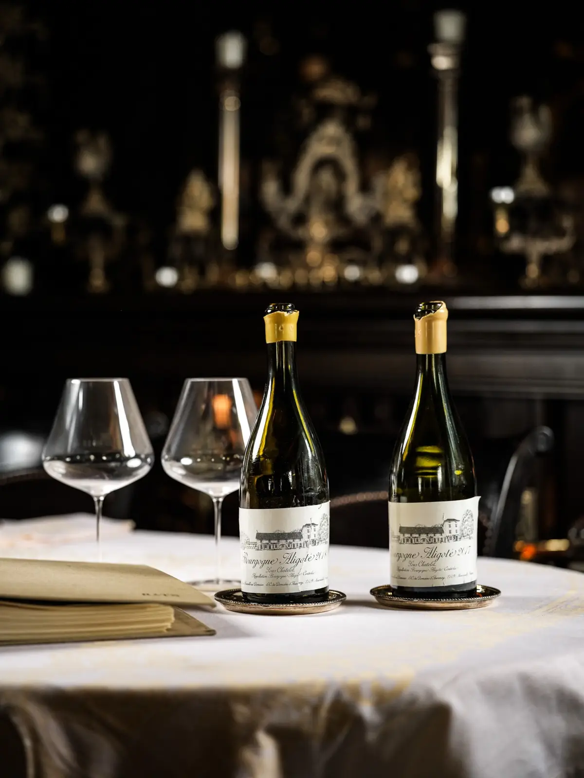 Two great Burgundy wines on a white tablecloth