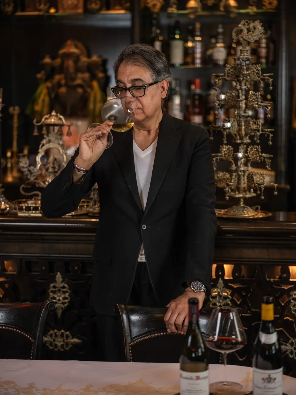 Sanjeev Bhalla tasting wine in the RATN dining room